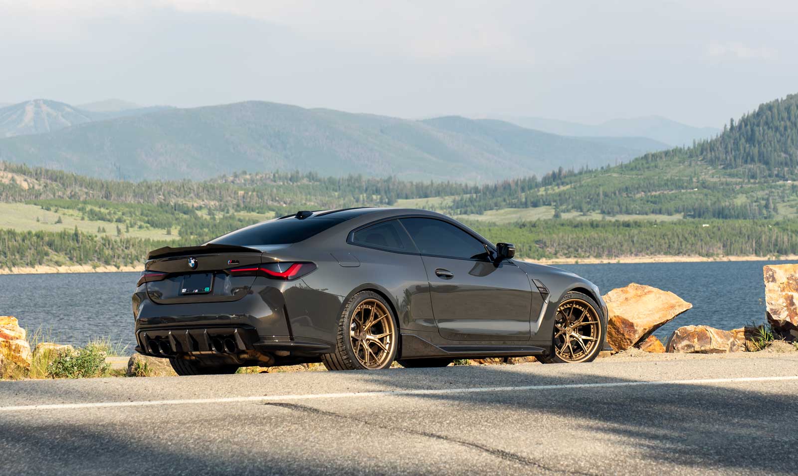 bmw g82 m4 parked by a lake