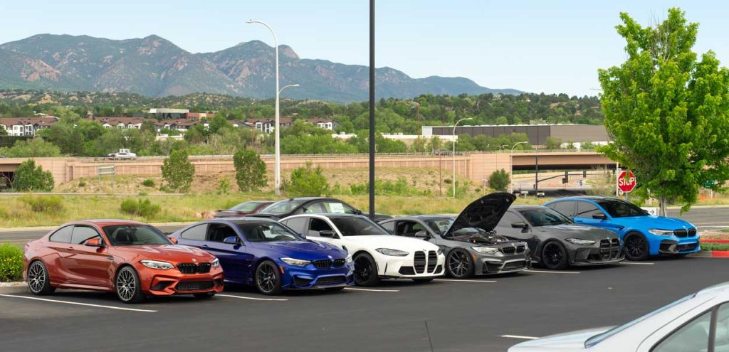 bmw M vehicles lined up at a car show