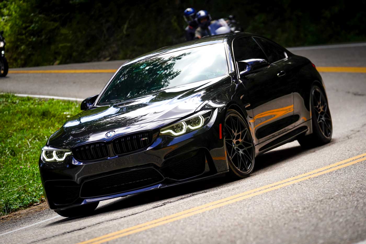 f82 bmw m4 driving around a curve