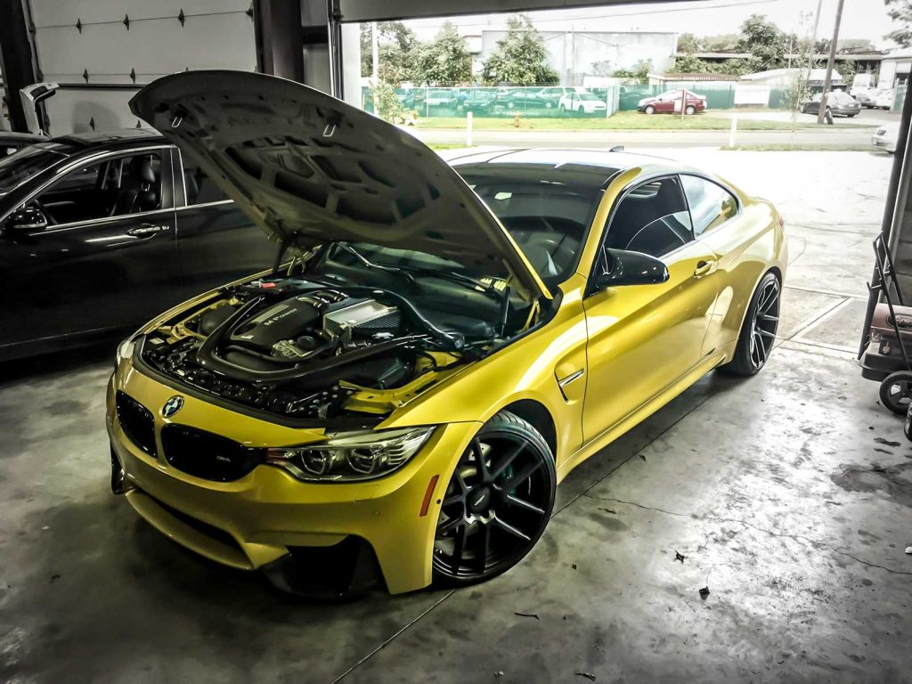 bmw f82 m4 with the hood open showing s55 engine